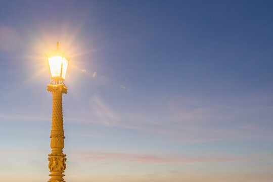 Germany, Mecklenburg-Vorpommern, Schwerin, Long exposure of Schwerin Castle street light glowing against sky at dusk - Powered by Adobe