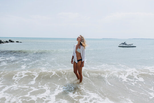 Smiling woman standing at beach