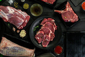  fresh beef meat on black background from top view 