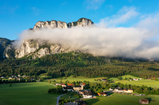 Austria, Upper Austria, Sankt Lorenz, Drone view of fog gathering over village at foot of Drachenwand mountain