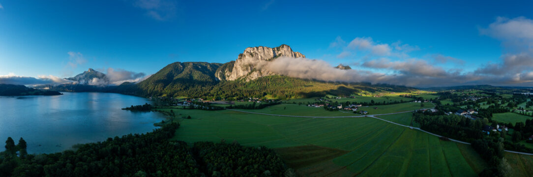 Austria, Upper Austria, Sankt Lorenz, Drone panorama of village and surrounding landscape at foggy dawn