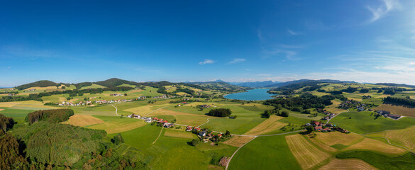 Austria, Upper Austria, Drone panorama of rural landscape surrounding Irrsee lake in summer