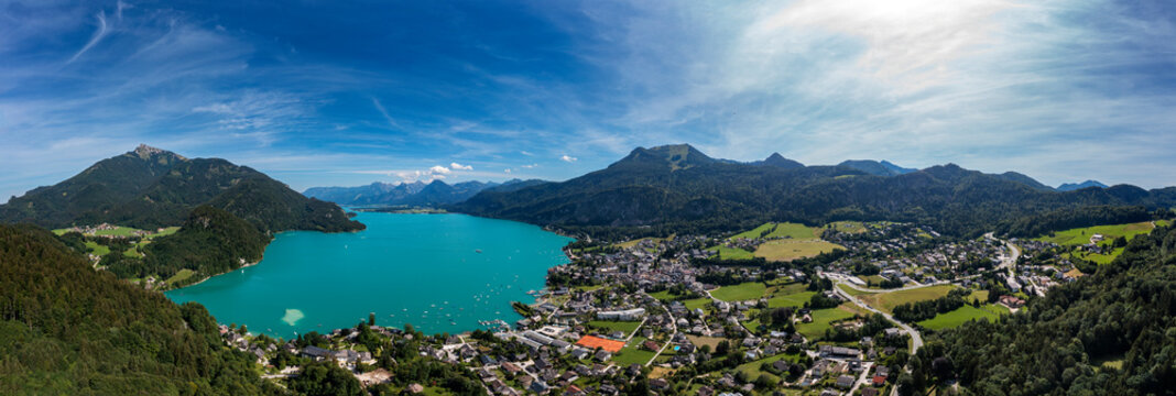 Austria, Upper Austria, Sankt Gilgen, Drone panorama of Lake Wolfgangsee and surrounding town in summer