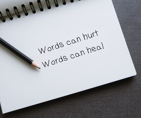 Notebook with handwritten text Words can hurt Words can heal - to remind language have power to...