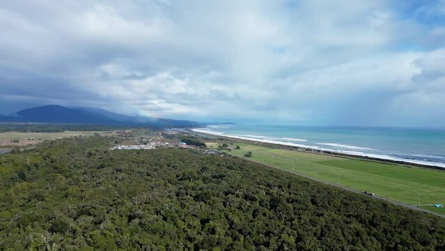 Hokitika, New Zealand: Dramatic Aerial Drone Footage Of The Coastal Road By The Tasman Sea Near The Hokitika Town In New Zealand South Island West Coast On A Cloudy Winter Day