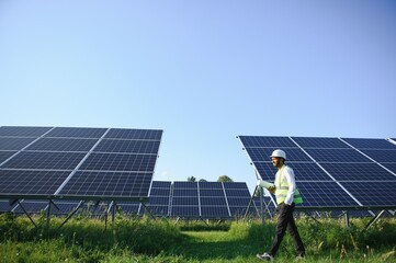 Portrait young indian technician or manager wearing formal cloths standing with solar panel....