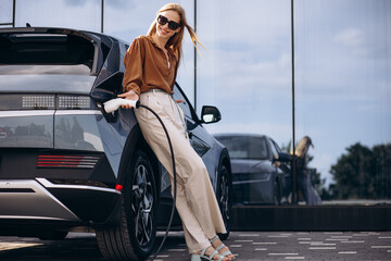 Woman charging electric car