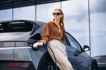 Woman charging electric car