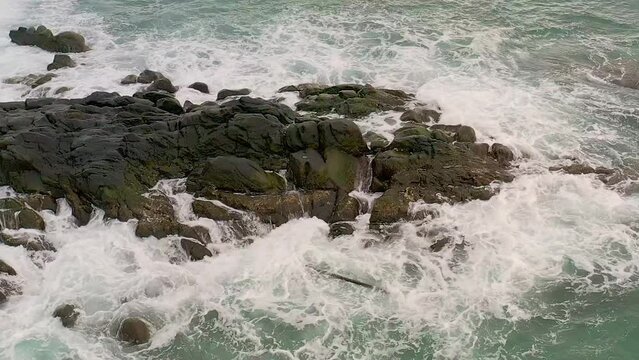 Aerial Drone Captures Powerful Ocean Waves in Slow Motion on the Rocky Coast of Looc Bay, Philippines.