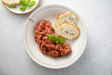 Traditional steak tartare with baguette bread