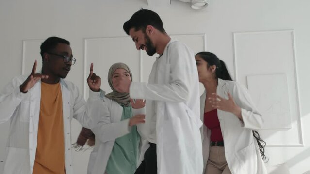 Modern Hospital Stuff Of Doctors Interns Nurses Dancing Excited In Front Of The Camera, Main Doctor Man And His Crazy Team Of Nurses And Doctors Celebrating Teamwork, Having Fun Together