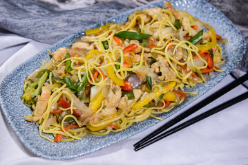 chicken chowmein and vegetable chow mein and chopsticks served in dish isolated on food table top view of middle east spices
