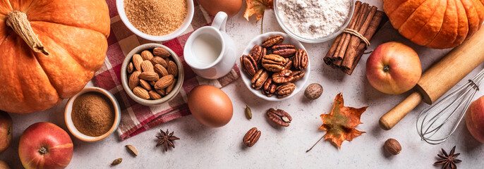 Autumn baking background with pumpkins, apples and nuts