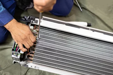 Foto op Plexiglas Technician is fixing or checking the evaporator system, troubleshooting air conditioning unit or dismantling for air conditioner fan coil unit cleaning,repair and maintenance,install air conditioner © Satjawat