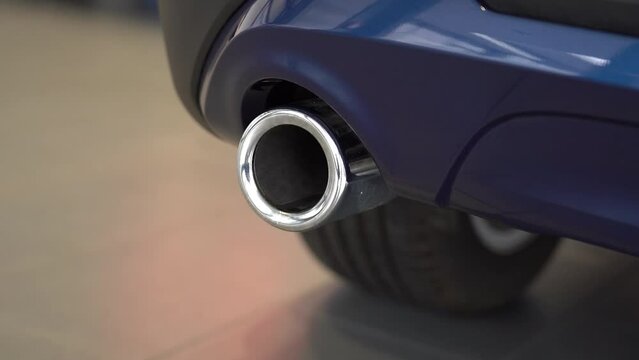 Kyiv, Ukraine - APRIL 12, 2023: Blue BMW X1 Exhaust pipe to other BMW moving