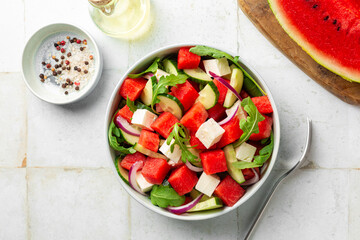 Top view of Fresh summer salad with watermelon, arugula, feta, cucumber salad, healthy food eating....