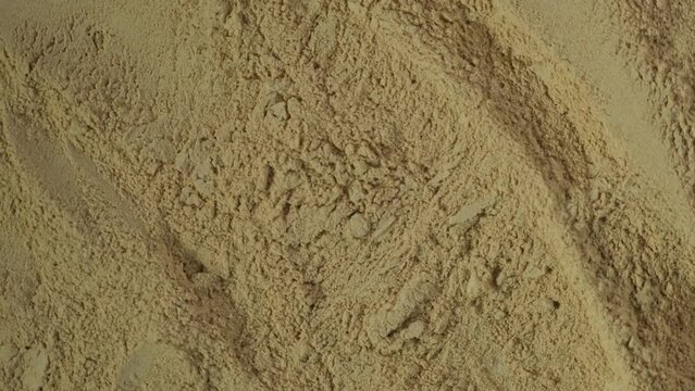 Pile of Maca powder, close-up. 4K video, Rotating. Maca gelatinized flour. Texture. Peruvian superfood, natural food supplement.