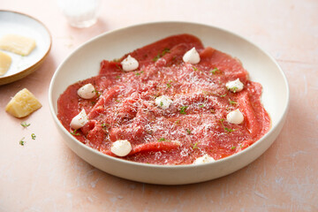 Homemade beef carpaccio with mayo and cheese