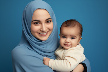 Studio portrait of beautiful woman mother holding her baby smiling on different colours background