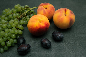 Plums, grapes, peaches. Still life with pears, grapes and plums. Healthy nutrition fruit delicious organic diet.