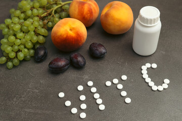 Organic fruits or pills. Healthy lifestyle, diet concept. Ripe delicious peach grapes plum or nutritional supplements. Diet vegan fruits and natural vitamins food