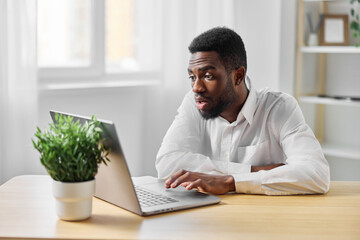 computer man office surprise distance american student laptop online african freelancer education