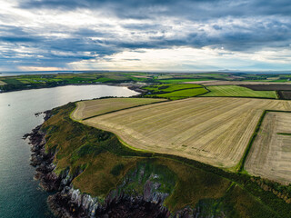 Sunset over Fields and Farms from a drone, Monk Haven Beach, Pembrokeshire Coast Path, Haverfordwest, Wales, England