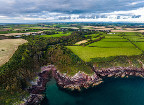 Sunset over Fields and Farms from a drone, Monk Haven Beach, Pembrokeshire Coast Path, Haverfordwest, Wales, England