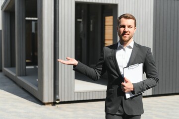 Closeup portrait of a confident male estate agent smiling