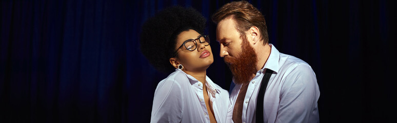 seductive african american woman in eyeglasses flirting near bearded businessman in office, banner