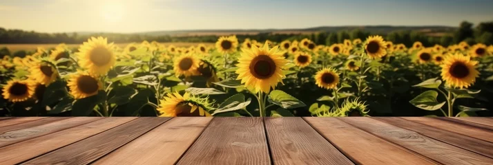 Poster Im Rahmen The empty wooden table top with sunflower field background, Product display template. © visoot