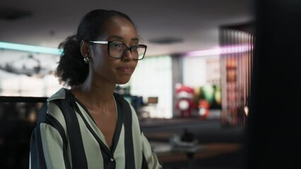 Close Up Portrait of Black Woman Using Desktop Computer, Analysing Data, Thinking and Solving Problems. Female Project Manager Working in Creative Agency, Reviewing Social Media Marketing Strategy.