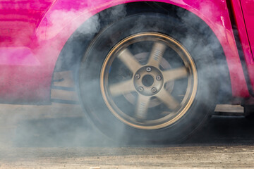 Close up car wheel with smoke on the asphalt road speed track, Car wheel drifting and smoking on...
