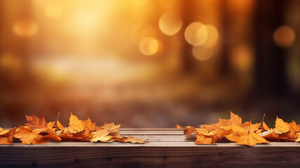 Fallen dry orange leaves on wooden boards against the backdrop of a blurry autumn park. - obrazy, fototapety, plakaty