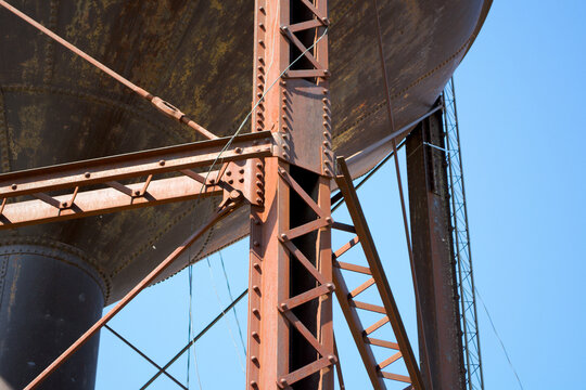 Closeup view looking up at the construction of an old water tower on Route 66 in Bristow, Oklahoma. Found at the old Santa Fe railroad depot.
