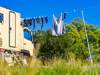 Camping. Clothes hanging to dry by rv lorry motorhome. © Voyagerix