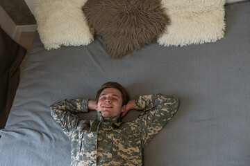 A closeup shot of a soldier sleeping in bed.
