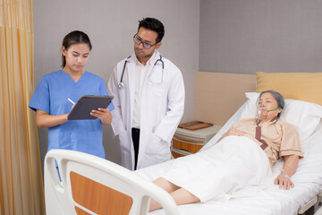 Fototapeta premium Specialist doctor and nurse explaining and check with elderly patient in hospital, medical and sick, diagnostic with report medical and health care on tablet, examining disease, senior and unwell.