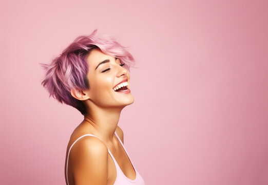 Woman with short sassy purple color hair, laughing away. On pink background, copy space.