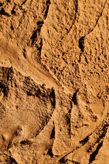 Decorative brown ocher putty background. Wall texture with filler paste applied with spatula,...