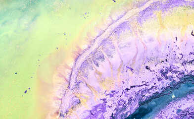 Multicolored creative abstract background. Lilac alcohol ink. Waves, stains, spots and strokes of paint, marble texture