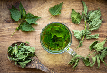 Above view of herbal tea made of dry Urtica dioica, known as common nettle, burn nettle or stinging...