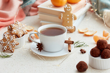 Aesthetic holidays food with coffee, tangerines, homemade gingerbread cookies, truffles and books. Aesthetic Christmas good mood background