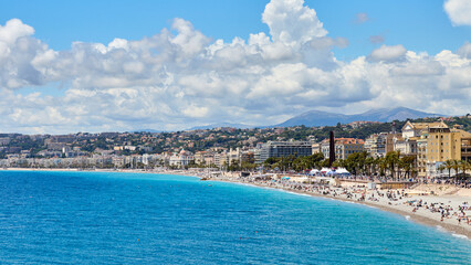 Panoramic view of Nice coastline and beach with blue sky and clouds, Provence-Alpes-Cote d'Azur, France, The French Riviera. - obrazy, fototapety, plakaty