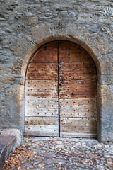 old medieva wall with very old wooden door