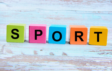 The word Sport on wooden cubes on a wooden background