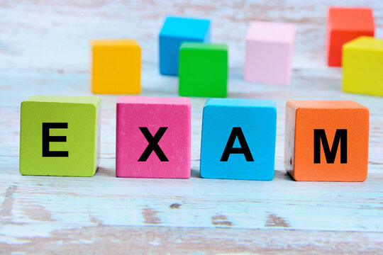 Wooden blocks Exam word concept on a wood table