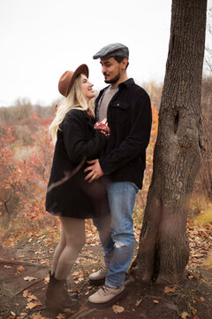 Full length image of a loving couple walking autumn in park