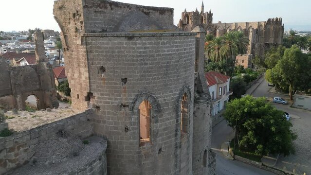 Revealing drone flight past ruins of St George of the Greeks Church, towards Lala Mustafa mosque, a former cathedral in Famagusta, history and religion in Northern Cyprus