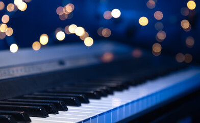 Piano keys close-up on a blurred background with bokeh.